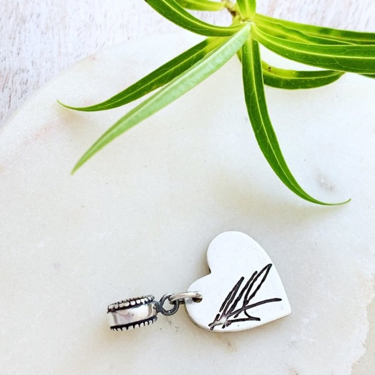 Charm made with loved one's signature on the reverse.